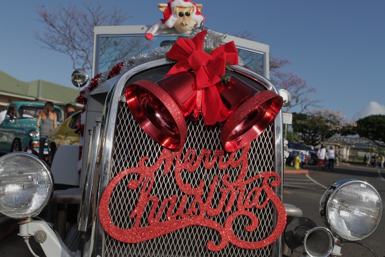 Photo of a Merry Christmas decal on a classic car decorated for Christmas.